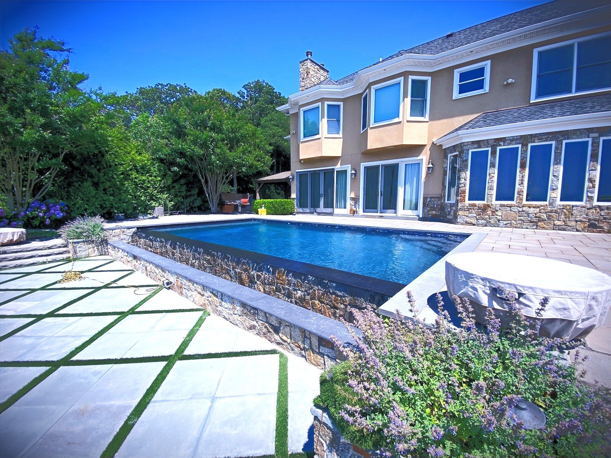 Custom pool with raised spa and landscaping