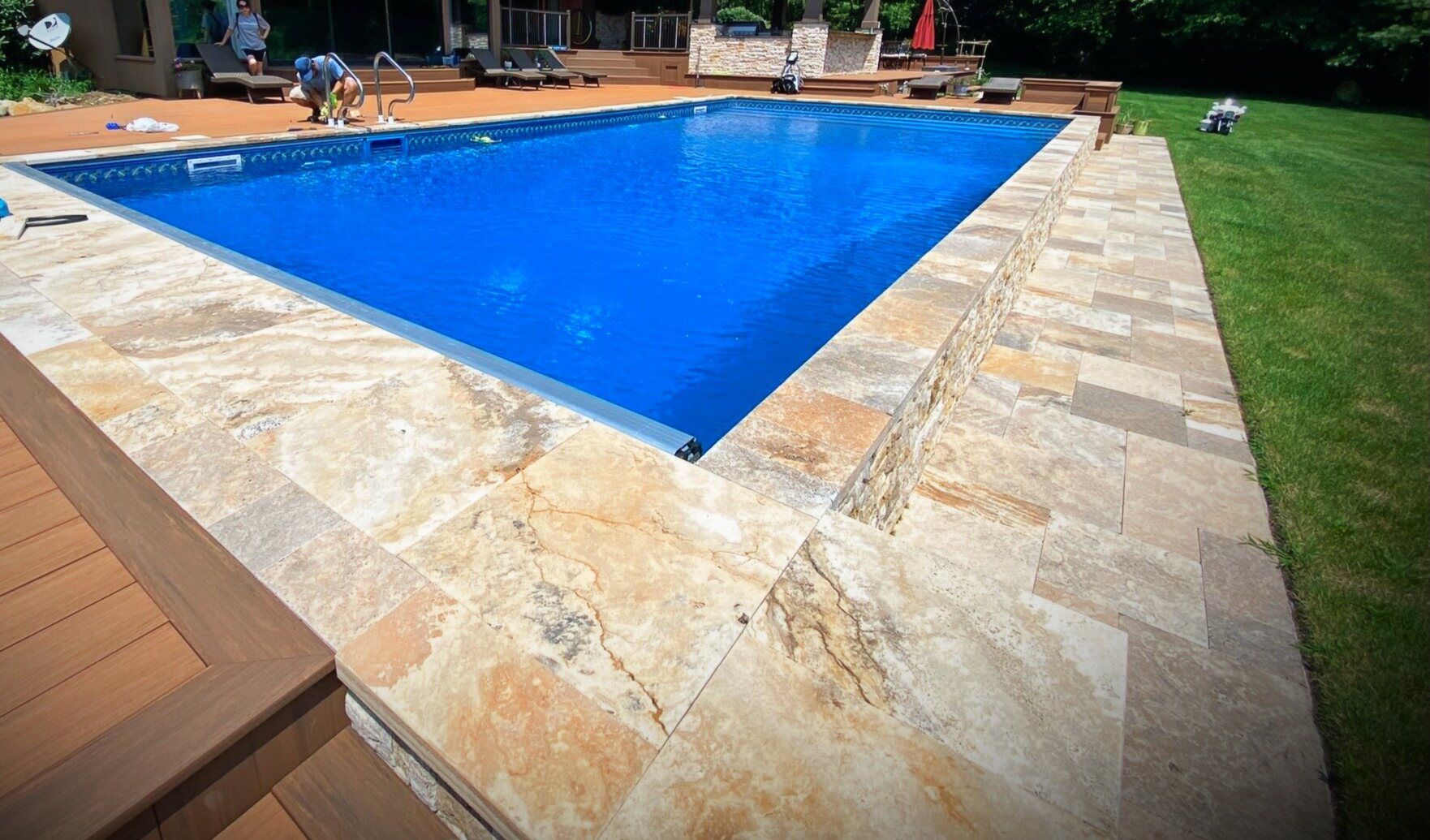 Semi-inground pool with stone surround